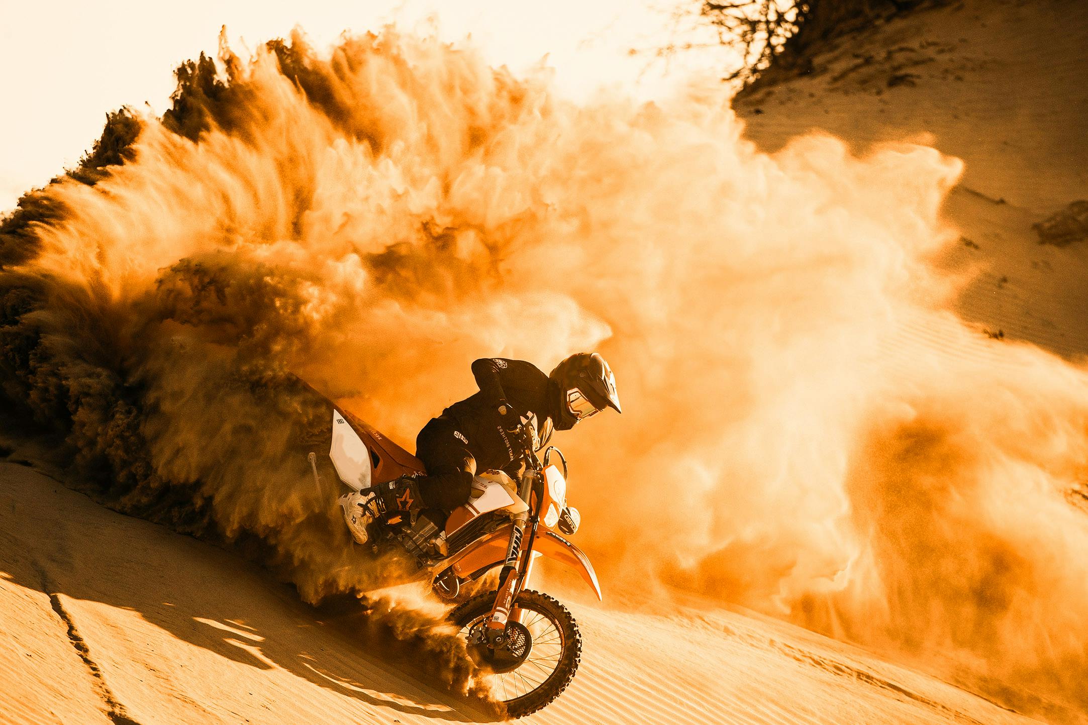 Enduro rider making a sand splash in the Sahara desert