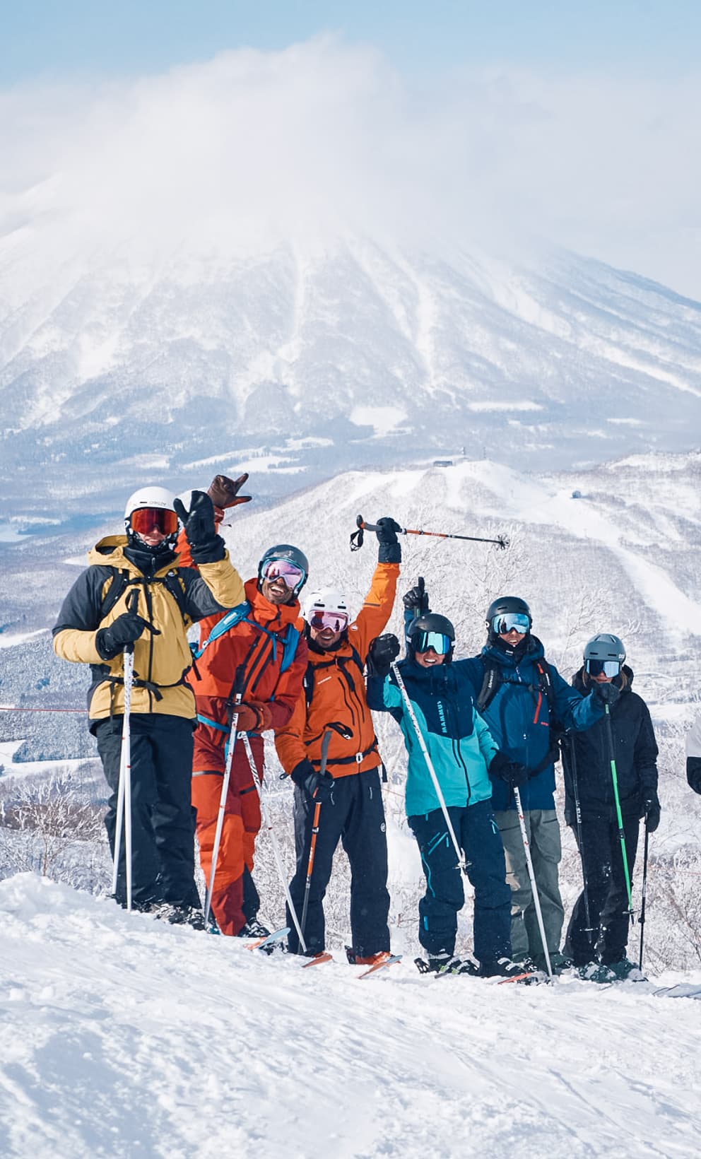 Friends skiing in Japan with Mount Yotei in the Background