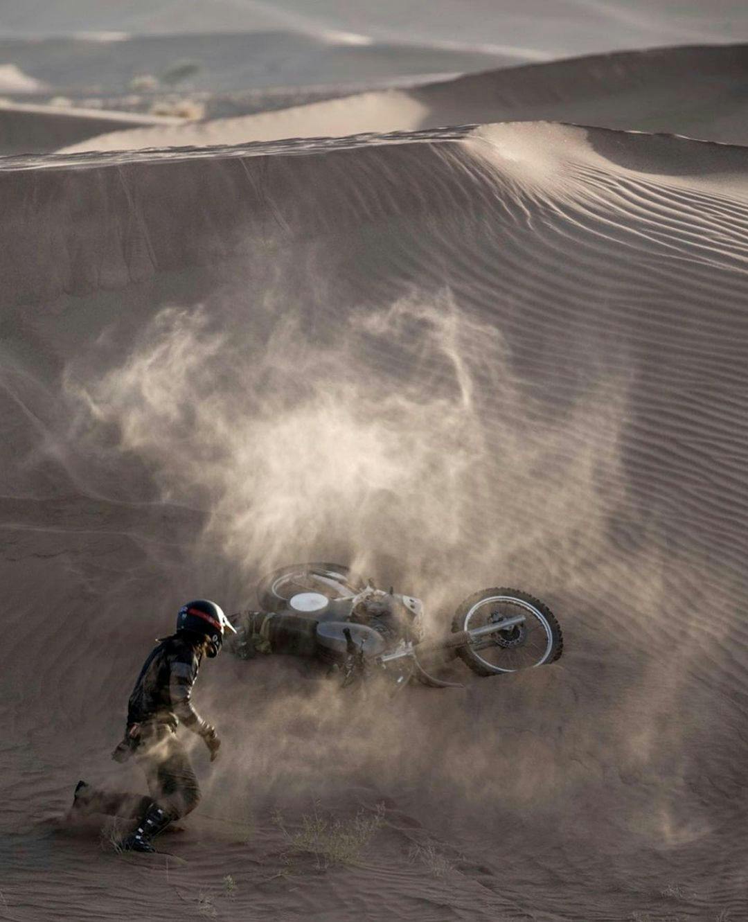 A man falling with his bike on the Sahara Dunes