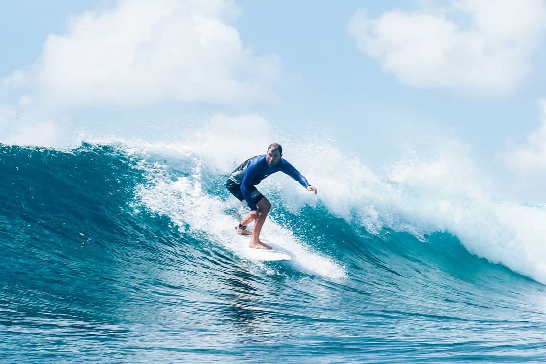 Dominique Catching a wave in the maldives surfing
