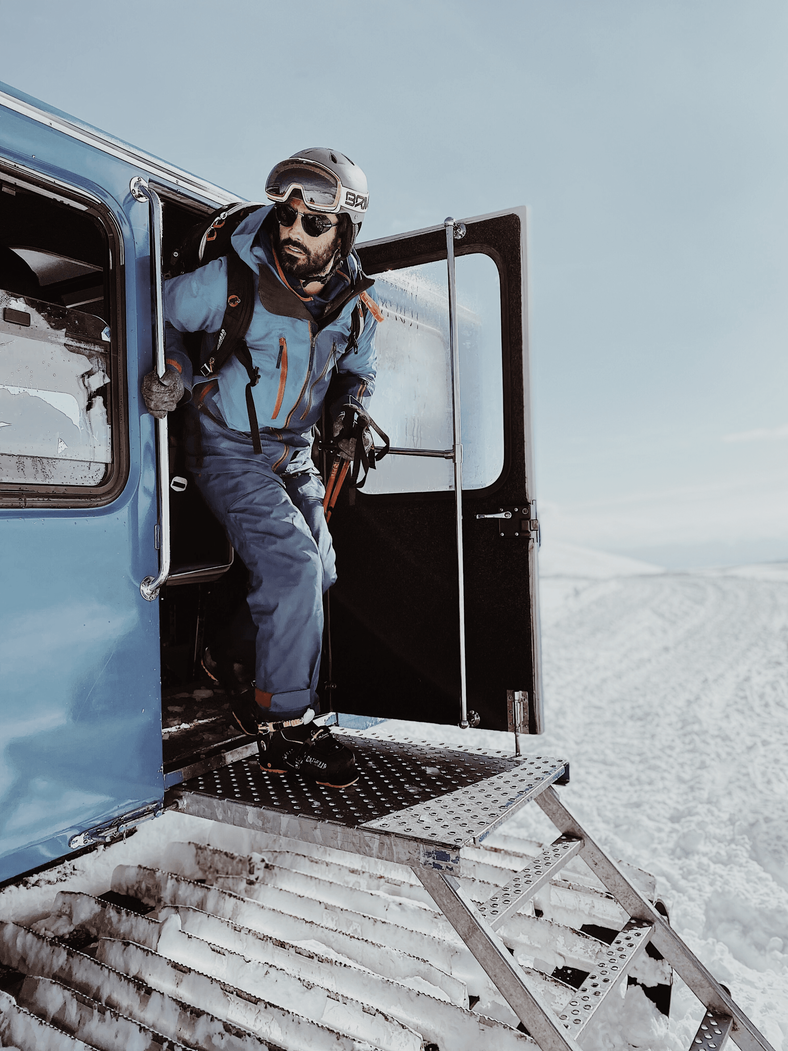 Men stepping out of Cat to ski
