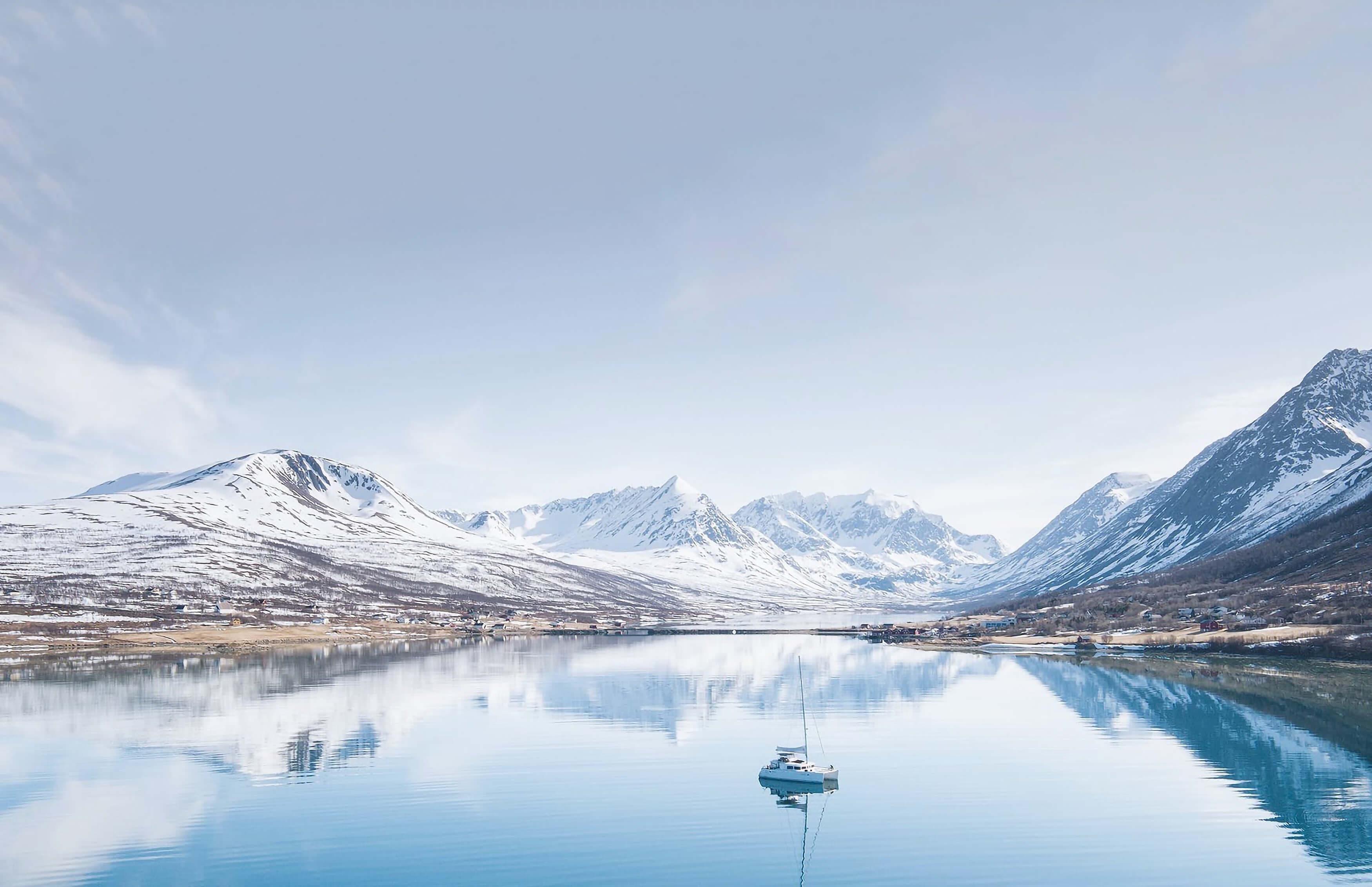 A boat in the Lyngen alps in the middle of a lake
