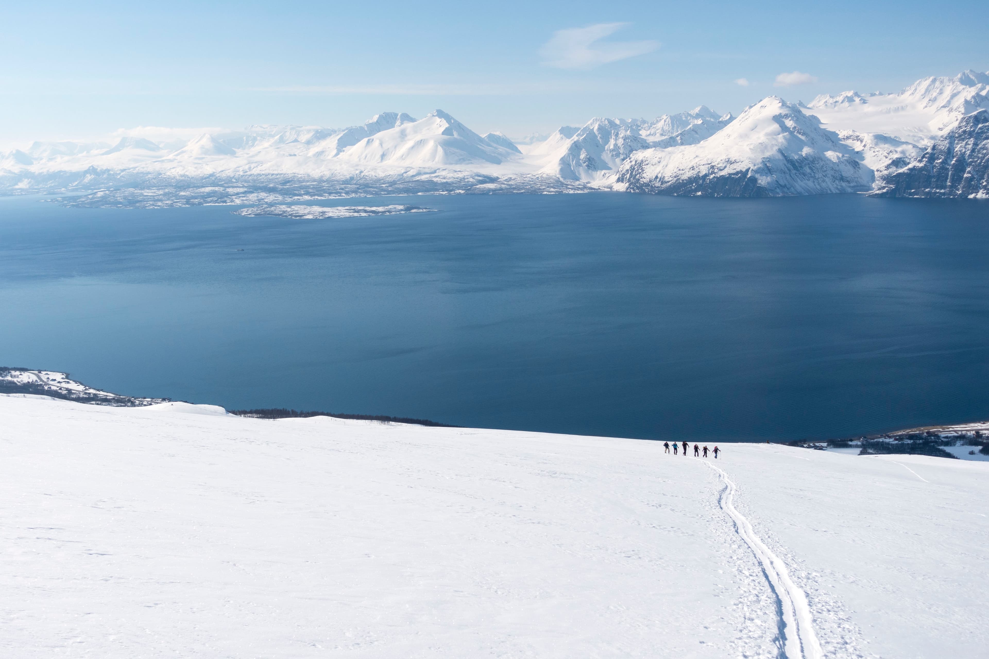 A group of 6 friends ski touring in the Lyngen Alps